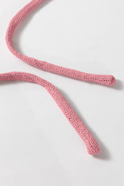 Dusty pink knit drawstring detail on a hoodie.