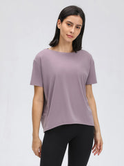 Relaxed fit performance tee in lilac with short sleeves and a boat neck.
