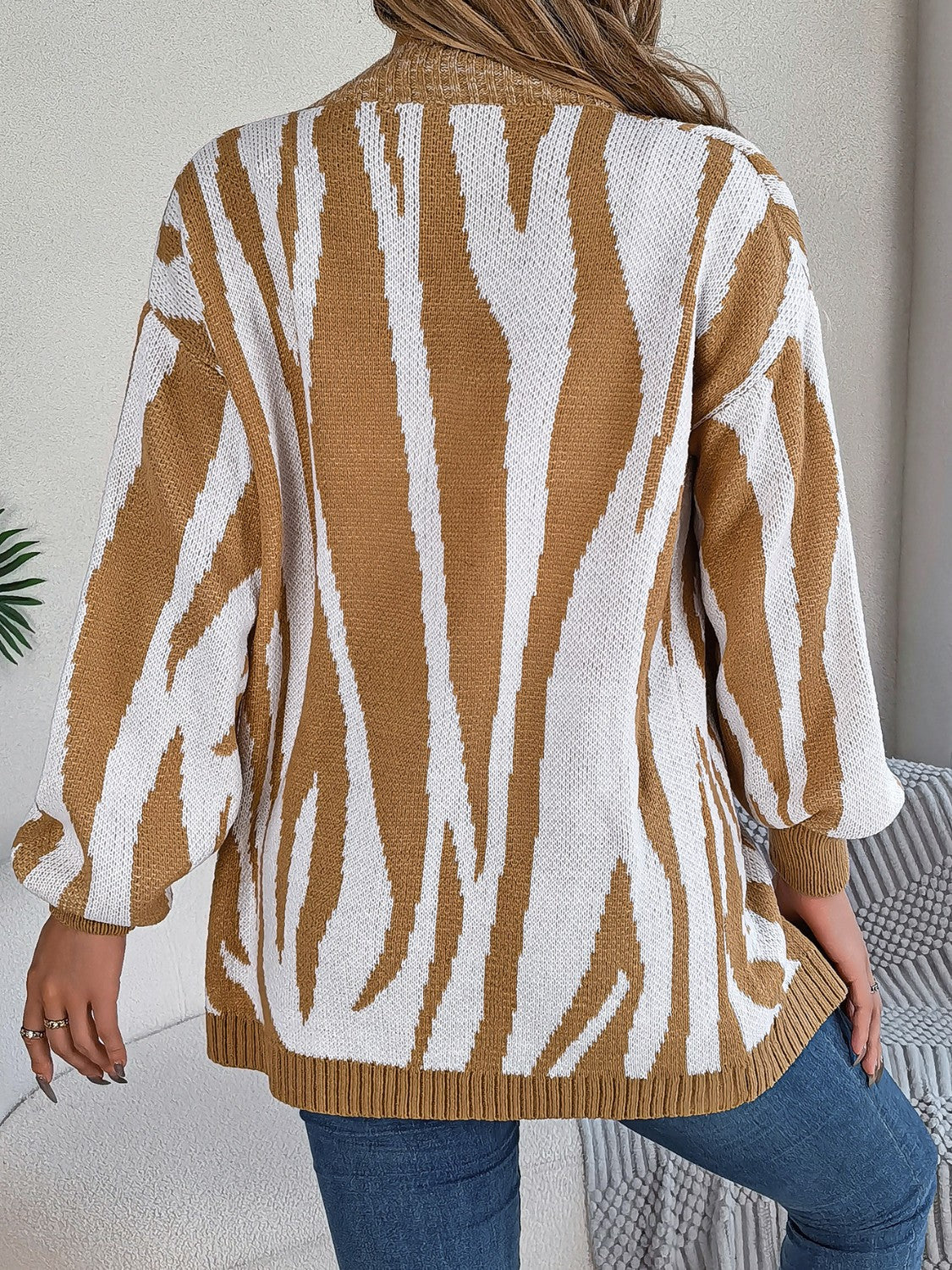 Caramel and white zebra stripe open-front knit cardigan with balloon sleeves.