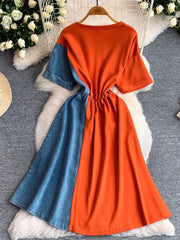 Color block casual dress with orange and denim panels, drawstring waist.