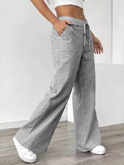 Chic striped drawstring maternity pants with pockets and wide legs.