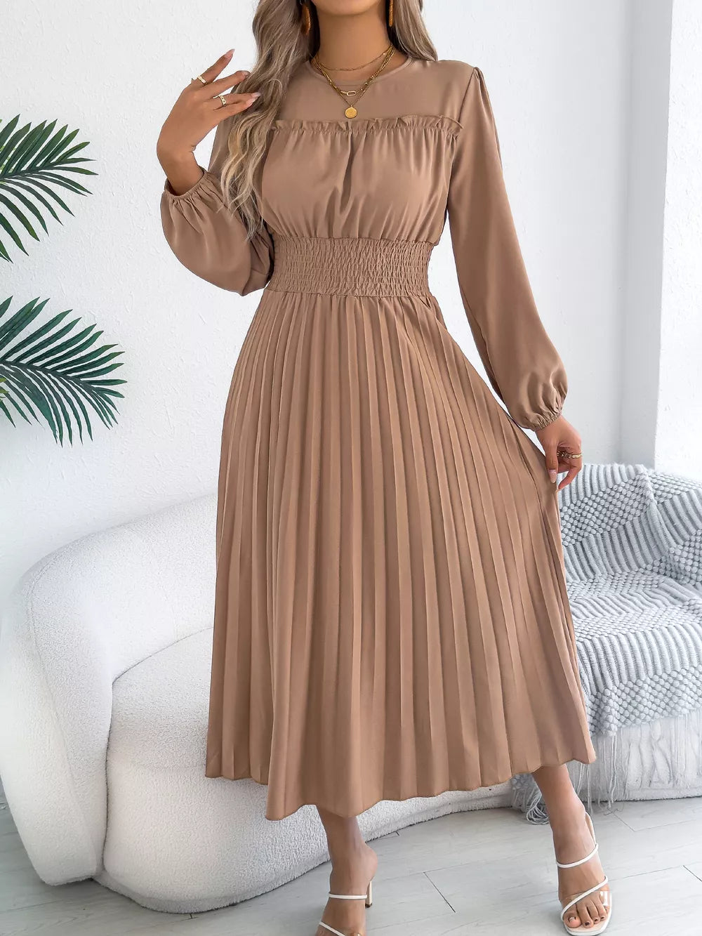 Khaki midi dress with ruffled neckline, smocked waist, and pleated skirt.