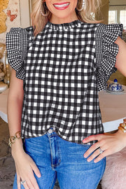 Black gingham blouse with ruffled sleeves and mock neck.