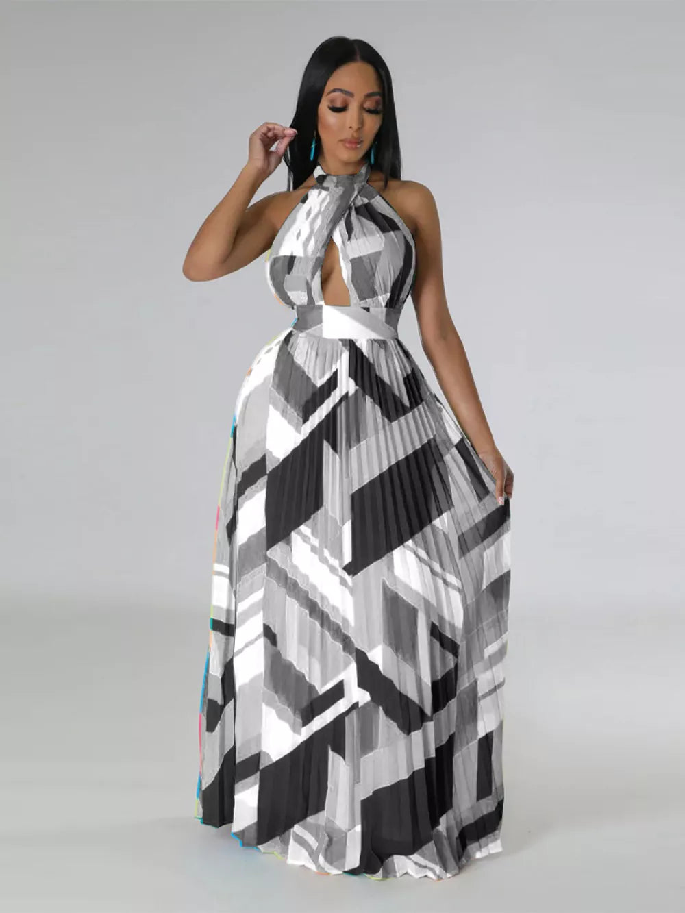 Halter neck maxi dress with geometric print, defined waistband, and pleated skirt.
