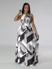 Halter neck maxi dress with geometric print, defined waistband, and pleated skirt.