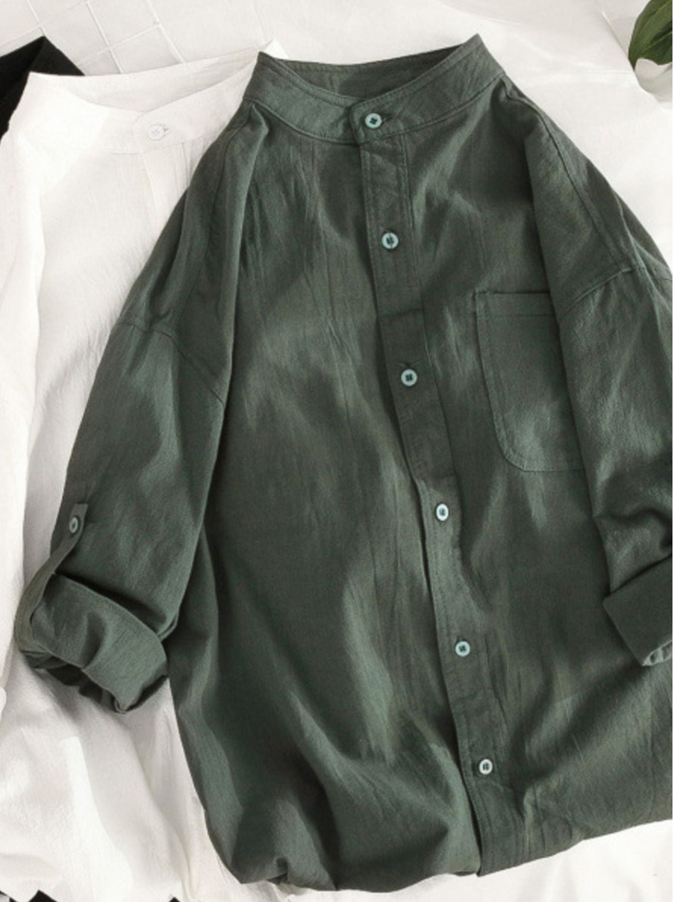 Men's casual button-up shirt in army green with band collar and chest pocket.