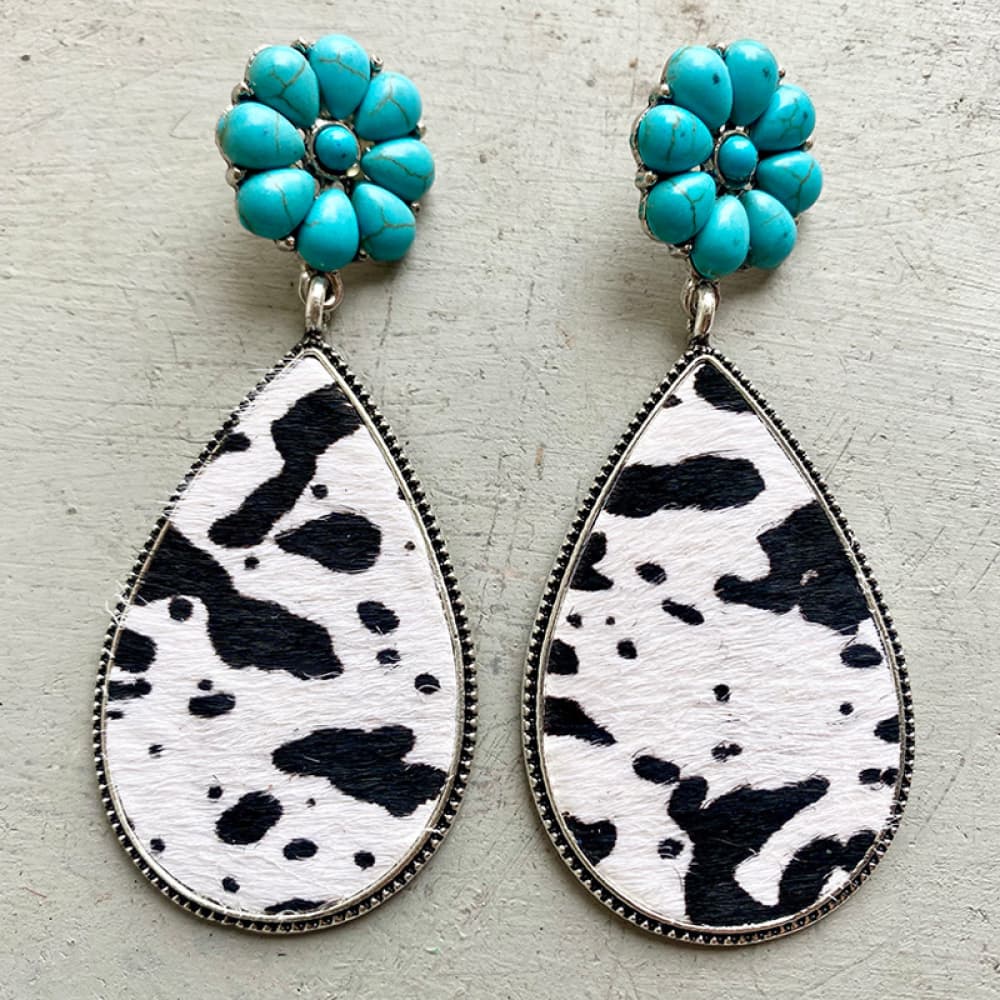 Turquoise petal stud earrings with black and white cowhide teardrop dangles.