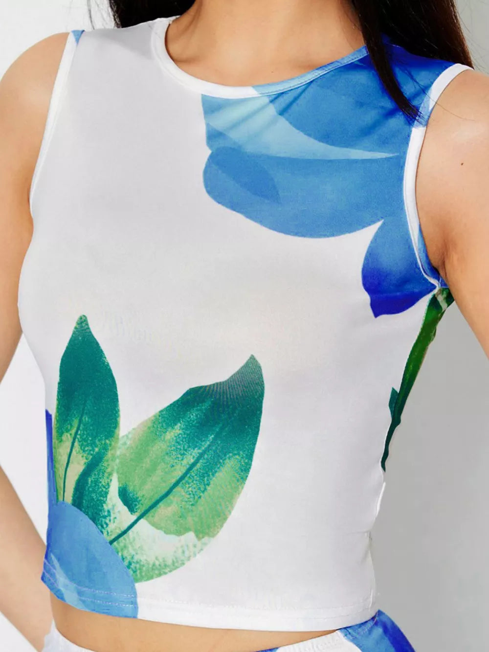 White floral crop top with blue and green abstract floral print
