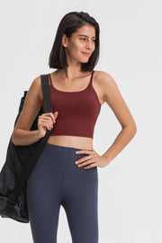 Rust scoop neck crop tank top with spaghetti straps, worn by a model with a gym bag.