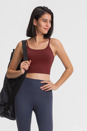 Rust scoop neck crop tank top with spaghetti straps, worn by a model with a gym bag.