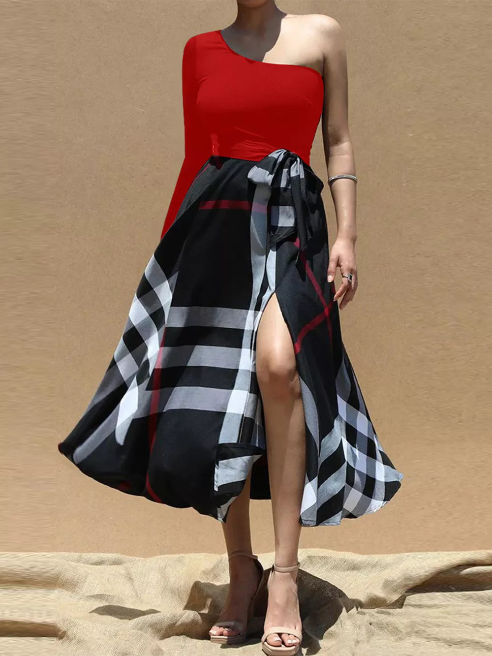Red one-shoulder midi dress with a black plaid wrap skirt and waist tie.