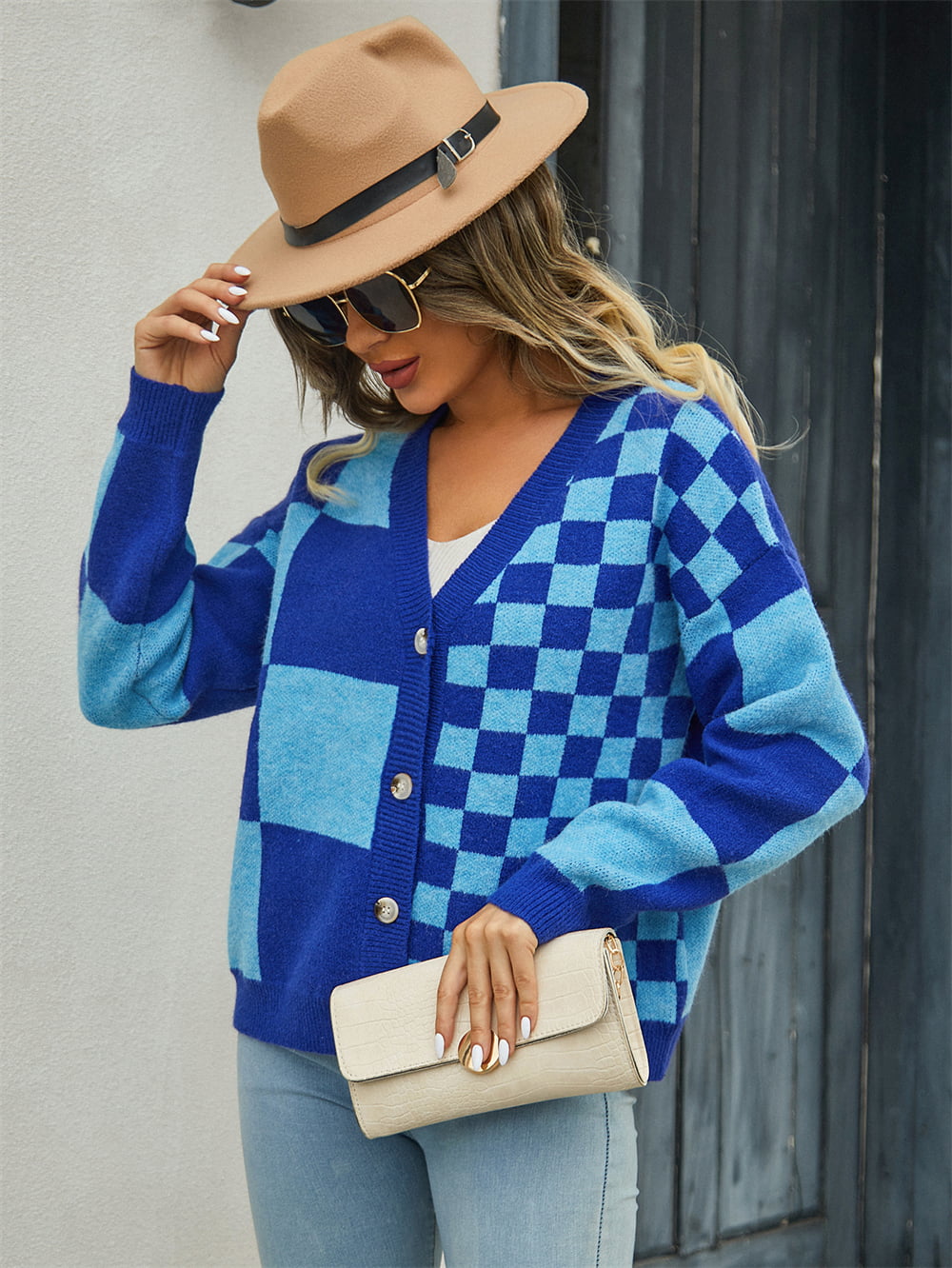 Checkerboard block knit cardigan in dark blue and light blue with button front.