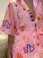 Pink co-ord set with whimsical celestial and floral print, featuring a button-down shirt and shorts.