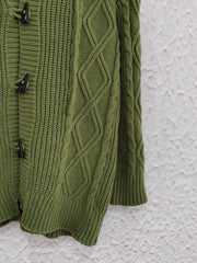 Moss green cable knit hoodie with toggle buttons and diamond pattern details.