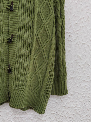 Moss green cable knit hoodie with toggle buttons and diamond pattern details.