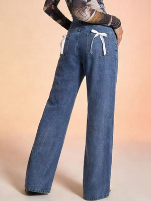 Maternity wide-leg jeans in blue denim with white bow back pocket details.