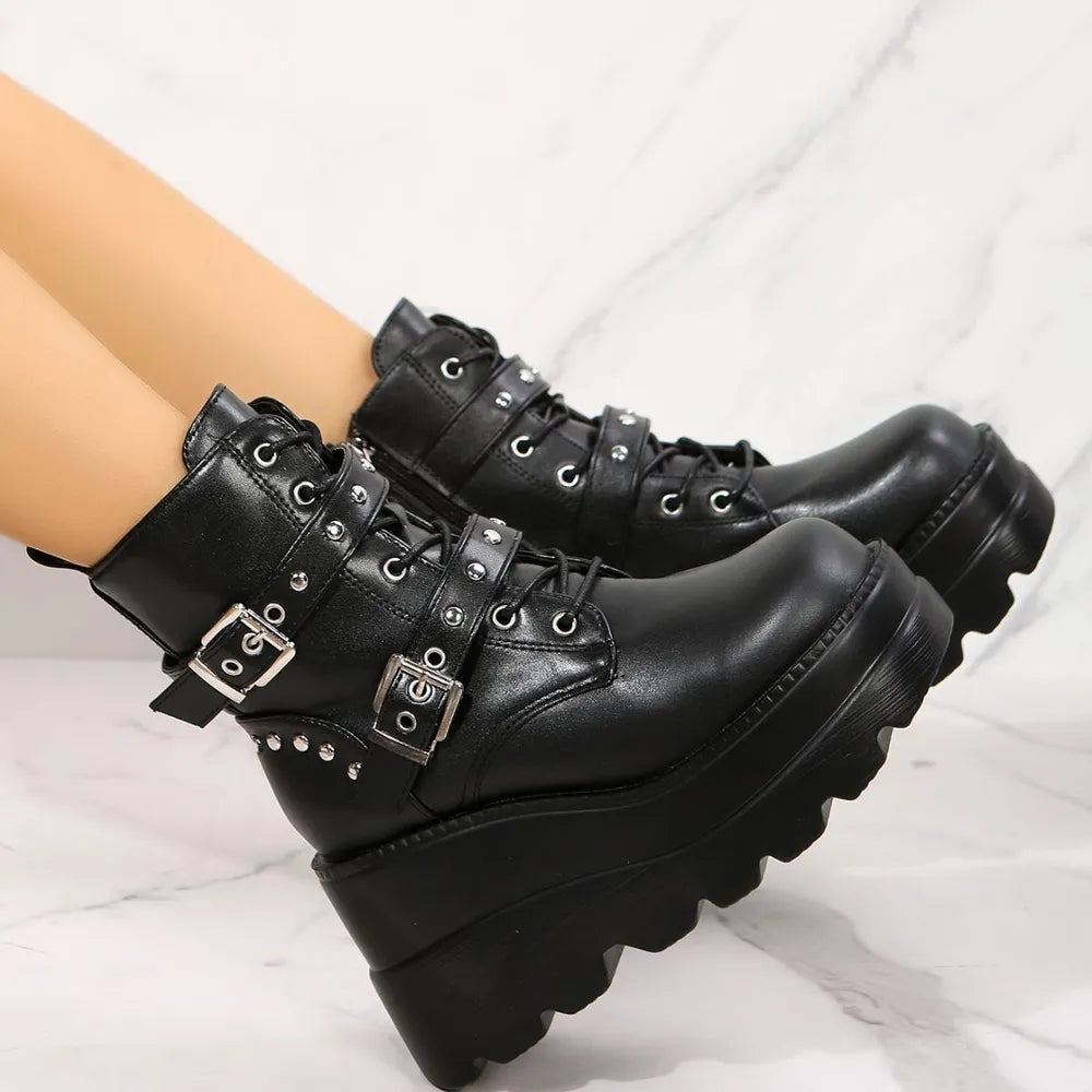 Black platform combat boots with multiple buckles and stud details.