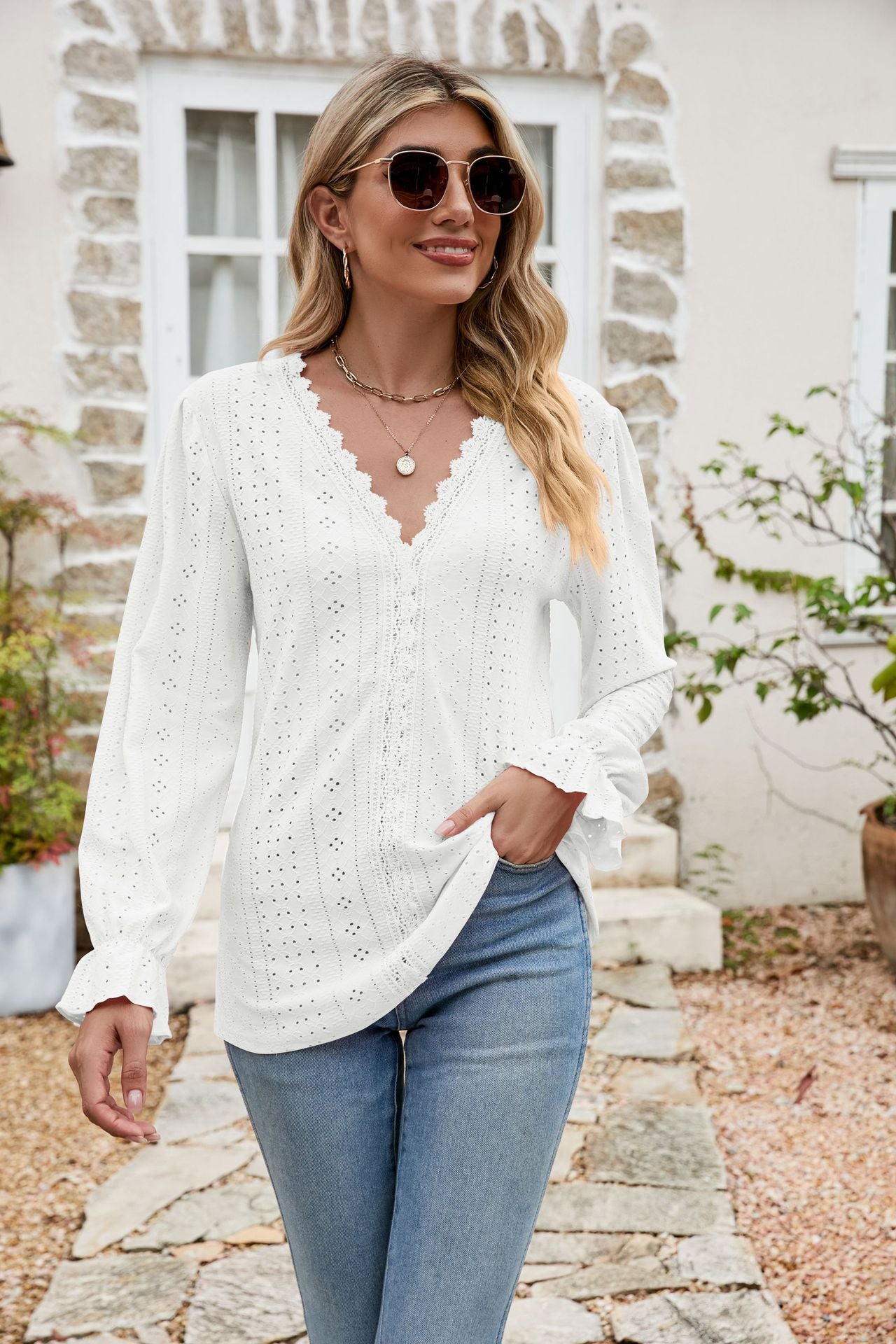 White eyelet lace blouse with ruffle sleeves and V-neckline