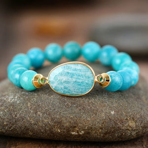 Aqua bead bracelet with gold bezel set oval stone detail