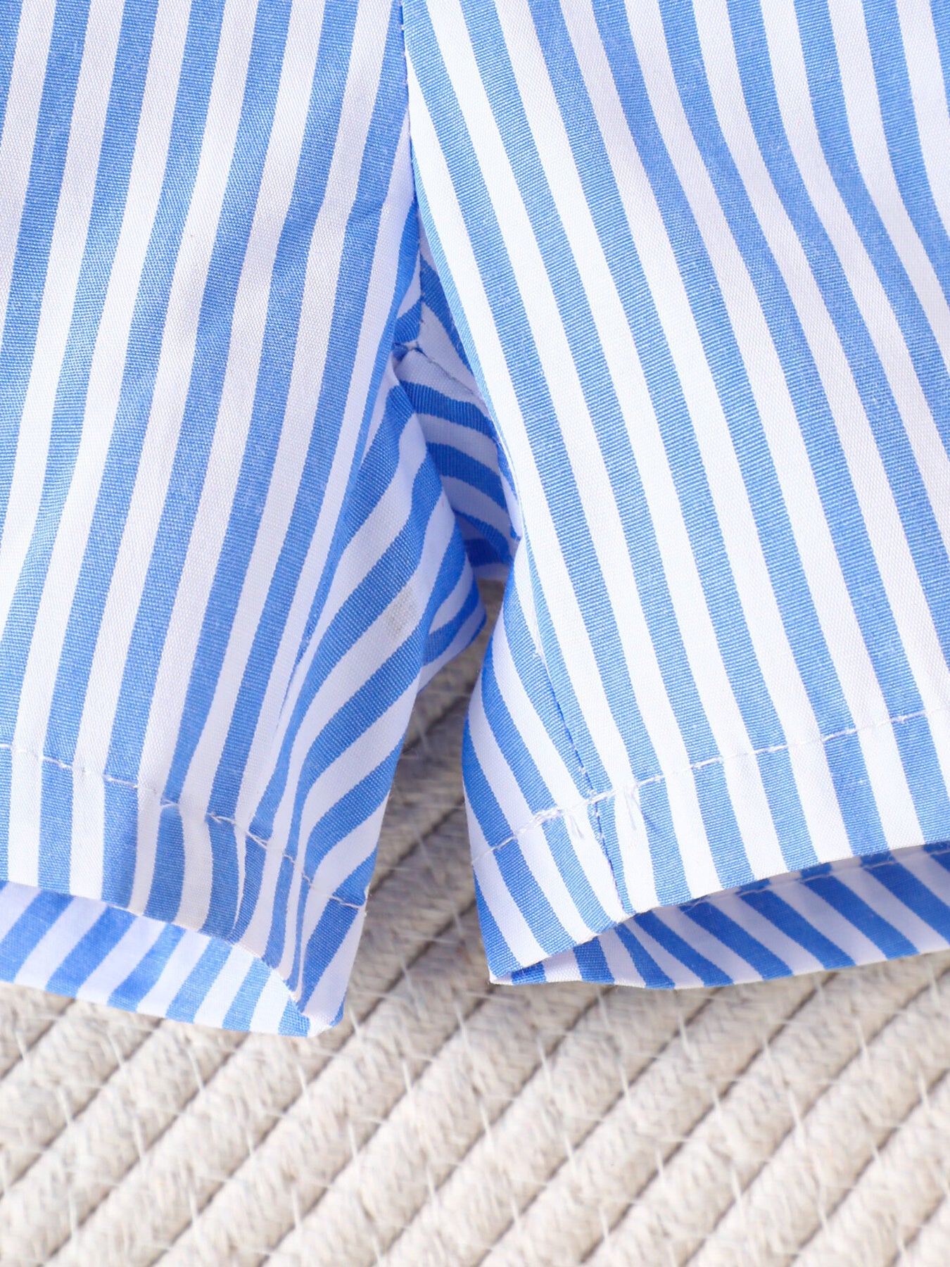 Baby shorts set in pastel blue and white stripes, cotton fabric, casual style.