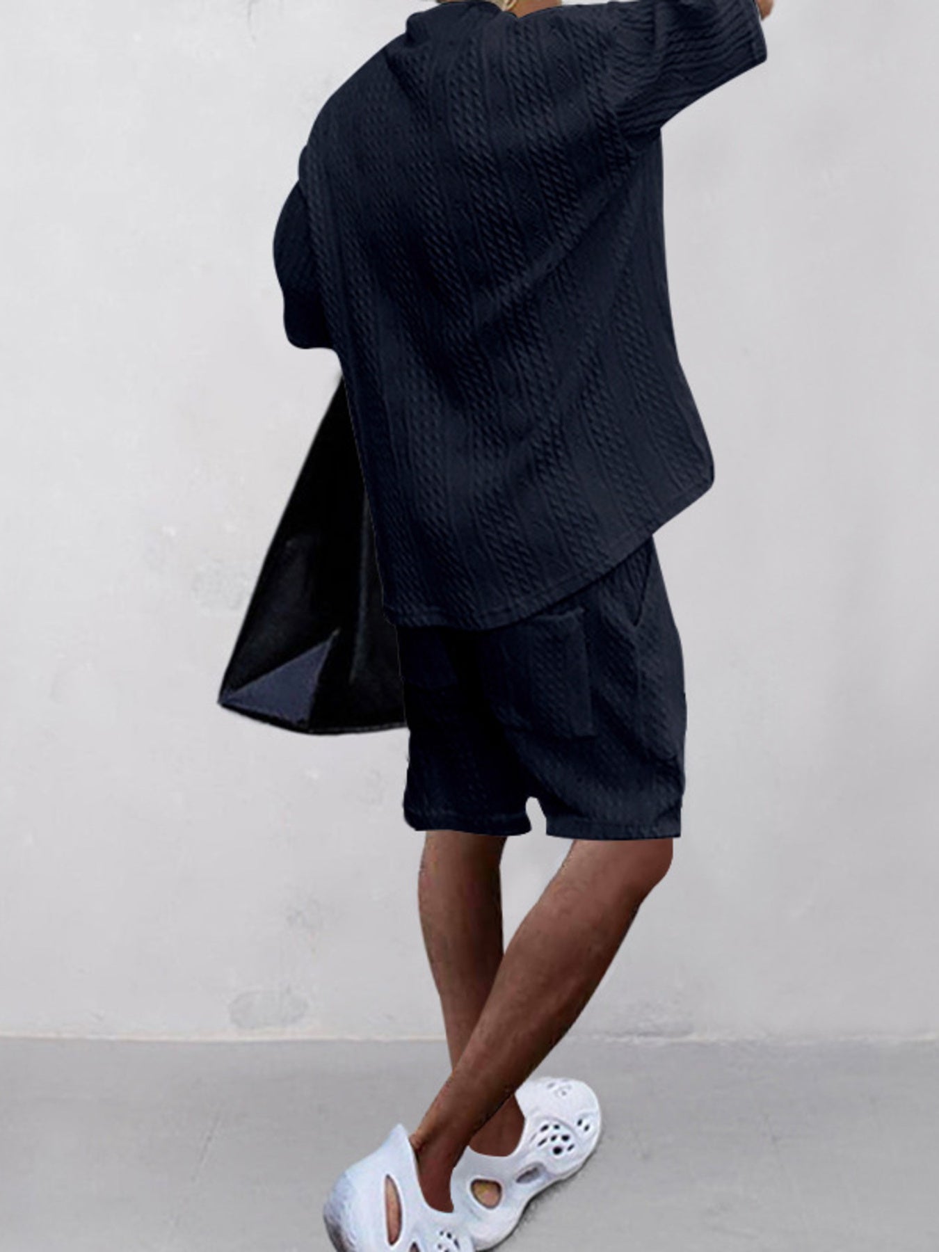 Navy blue cable-knit two-piece set with shorts and a short-sleeve V-neck top.