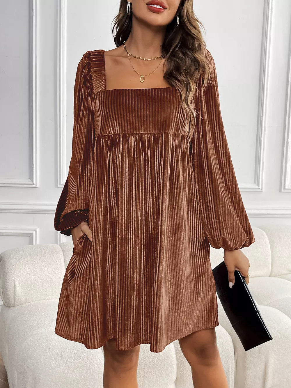 Brown velvet mini dress with square neckline, long puff sleeves, and pleated skirt.