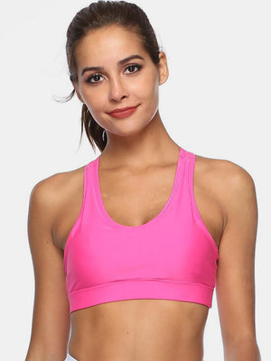 Pink racerback sports bra with scoop neckline and wide straps.
