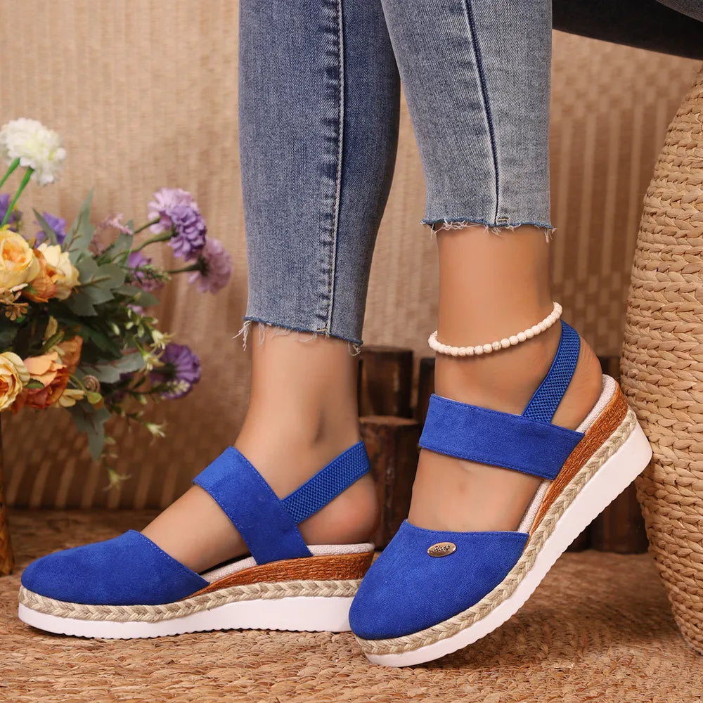 Royal blue espadrille wedge slingback sandals with a jute-wrapped sole and elastic ankle strap.
