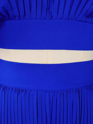 Blue pleated two-piece set with a cream waistband detail and wide legs.