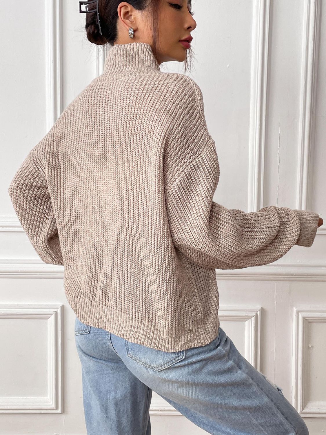 Khaki mock neck knit sweater with textured stitch and relaxed fit.