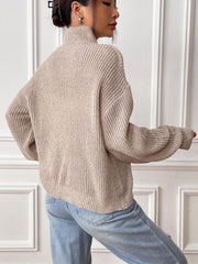 Khaki mock neck knit sweater with textured stitch and relaxed fit.