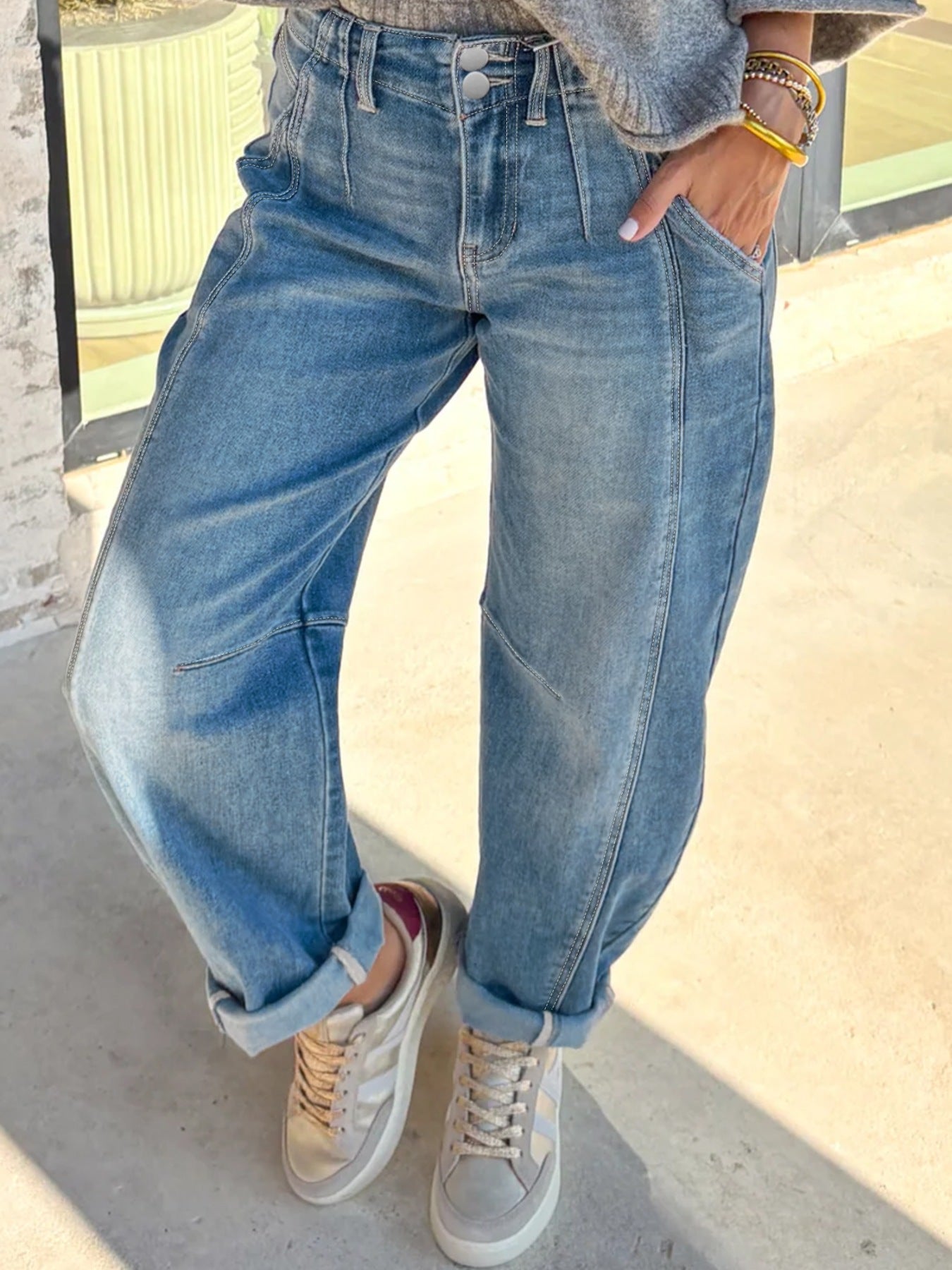 High-waisted light wash denim barrel jeans with cuffed hems and a relaxed fit.