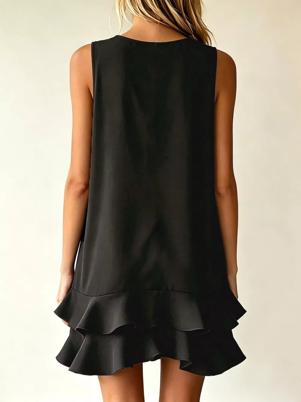 Black tiered ruffle mini dress with a sleeveless, A-line cut.