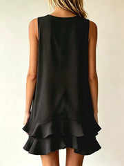 Black tiered ruffle mini dress with a sleeveless, A-line cut.