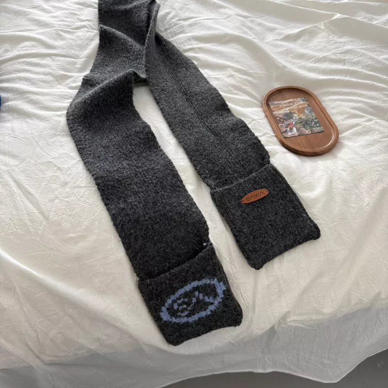 Gray textured knit scarf with pockets and a leather logo patch