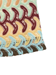 Crochet mini skirt with colorful wavy pattern and open knit detail.