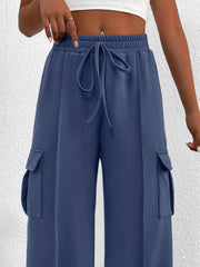 Blue high waist cargo sweatpants with drawstring and side pockets.