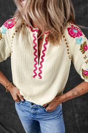 Beige embroidered sleeve voluminous blouse with pink zigzag neckline trim.