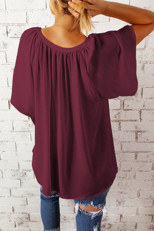 Wine relaxed V-neck blouse with gathered neckline and cap sleeves.