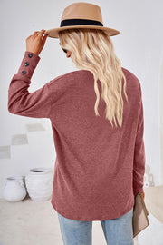 Rust V-neck top with button cuff detail on sleeves