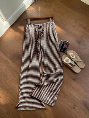 Maternity wide leg pants in dark brown and white stripes with a drawstring waist.