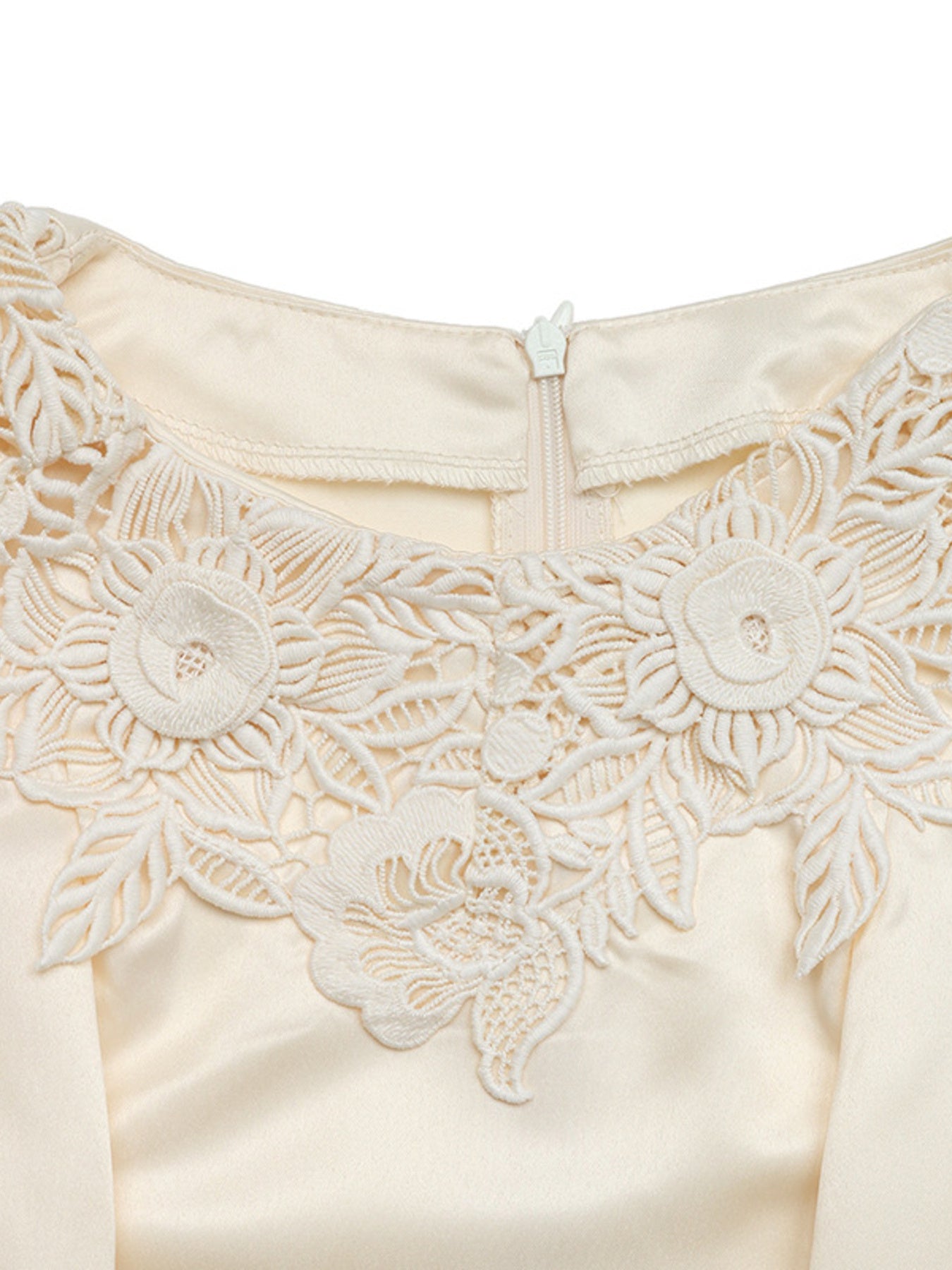 Apricot satin blouse with intricate floral lace neckline detail and zipper closure.