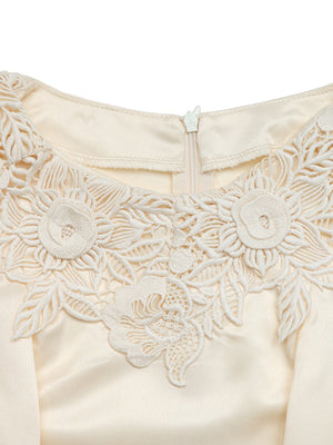 Apricot satin blouse with intricate floral lace neckline detail and zipper closure.