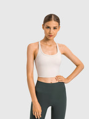 Sculpted racerback crop tank in beige with a scoop neckline and thin straps.