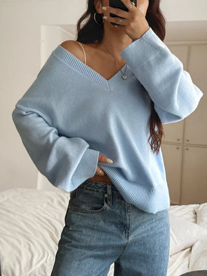 Light blue V-neck knit sweater with relaxed fit and ribbed cuffs.