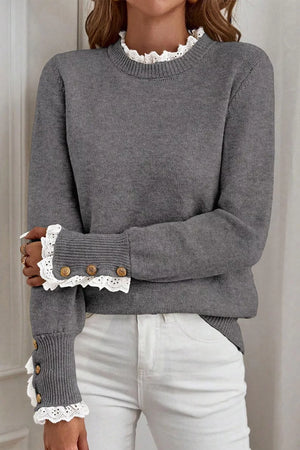 Dark gray knit sweater with mock neck and lace trim cuffs with buttons.