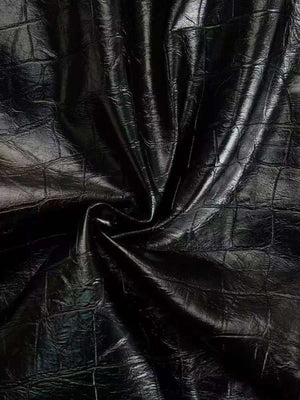 Black crocodile-embossed bodycon midi dress fabric detail.