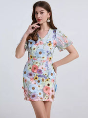 Sky blue mini dress with puff sleeves and colorful floral embroidery.