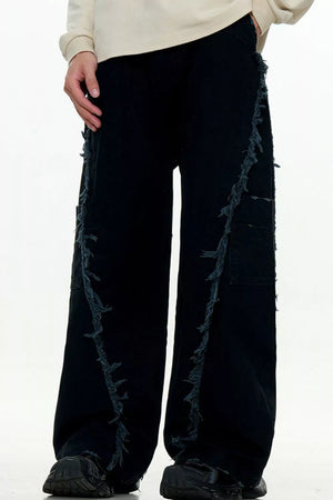 Black wide-leg sweatpants with distressed fringe detail down the sides.