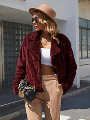 Burgundy faux fur biker jacket with a wide collar and open front, styled with a white crop top.